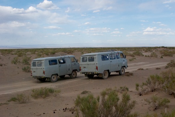 We came to a sand dune area and got out to poke around and take a break. Here's our faithful Russian vans.